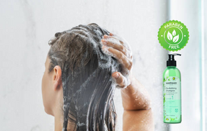 Woman washes her hair with paraben free shampoo