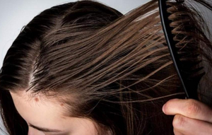 Woman comb her oily hair