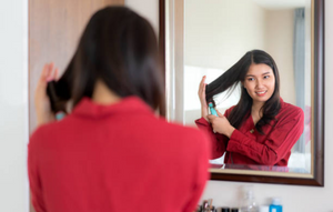 Asian woman takes care of her hair